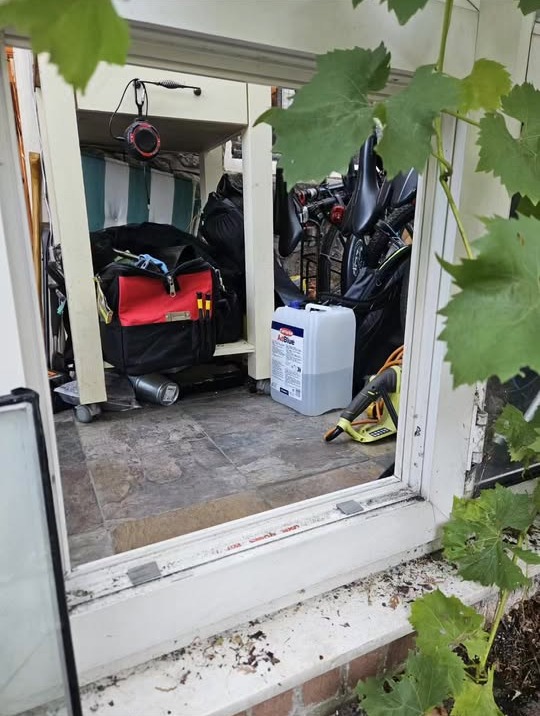 Window frame removed mid-replacement with a tool bag inside