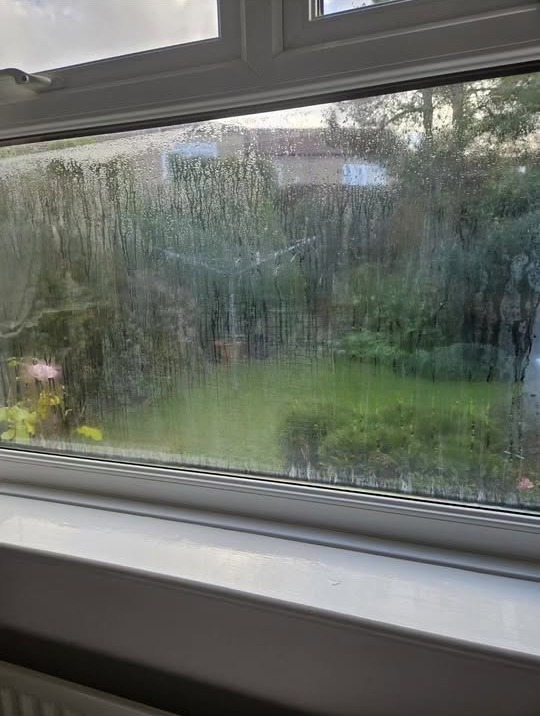 Misted double-glazed window unit with condensation trapped between the panes