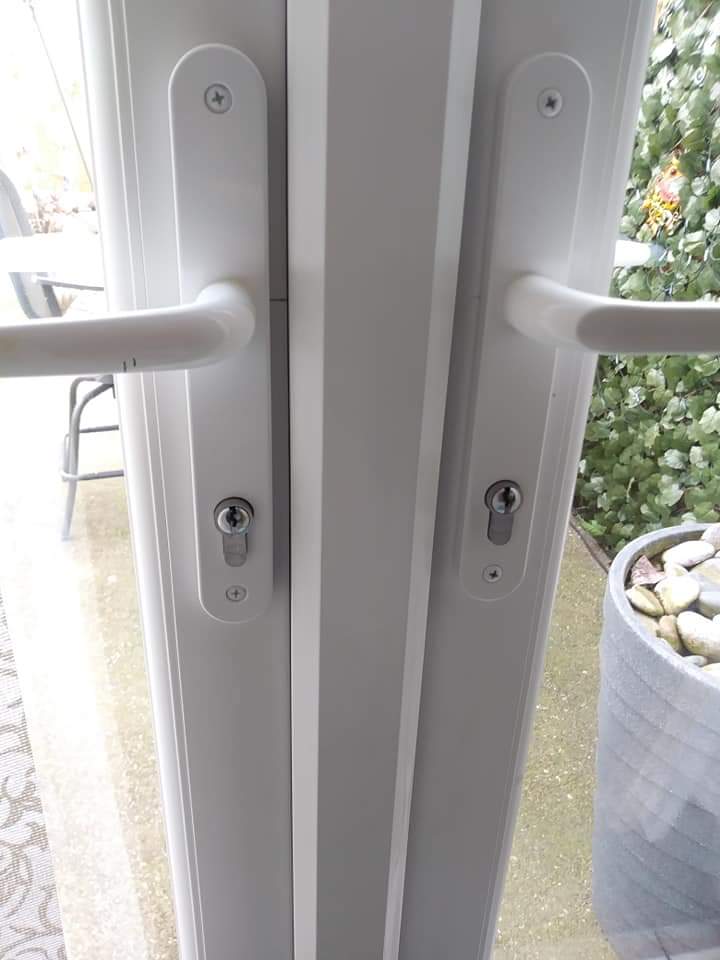 White uPVC French doors with two handles and euro cylinders