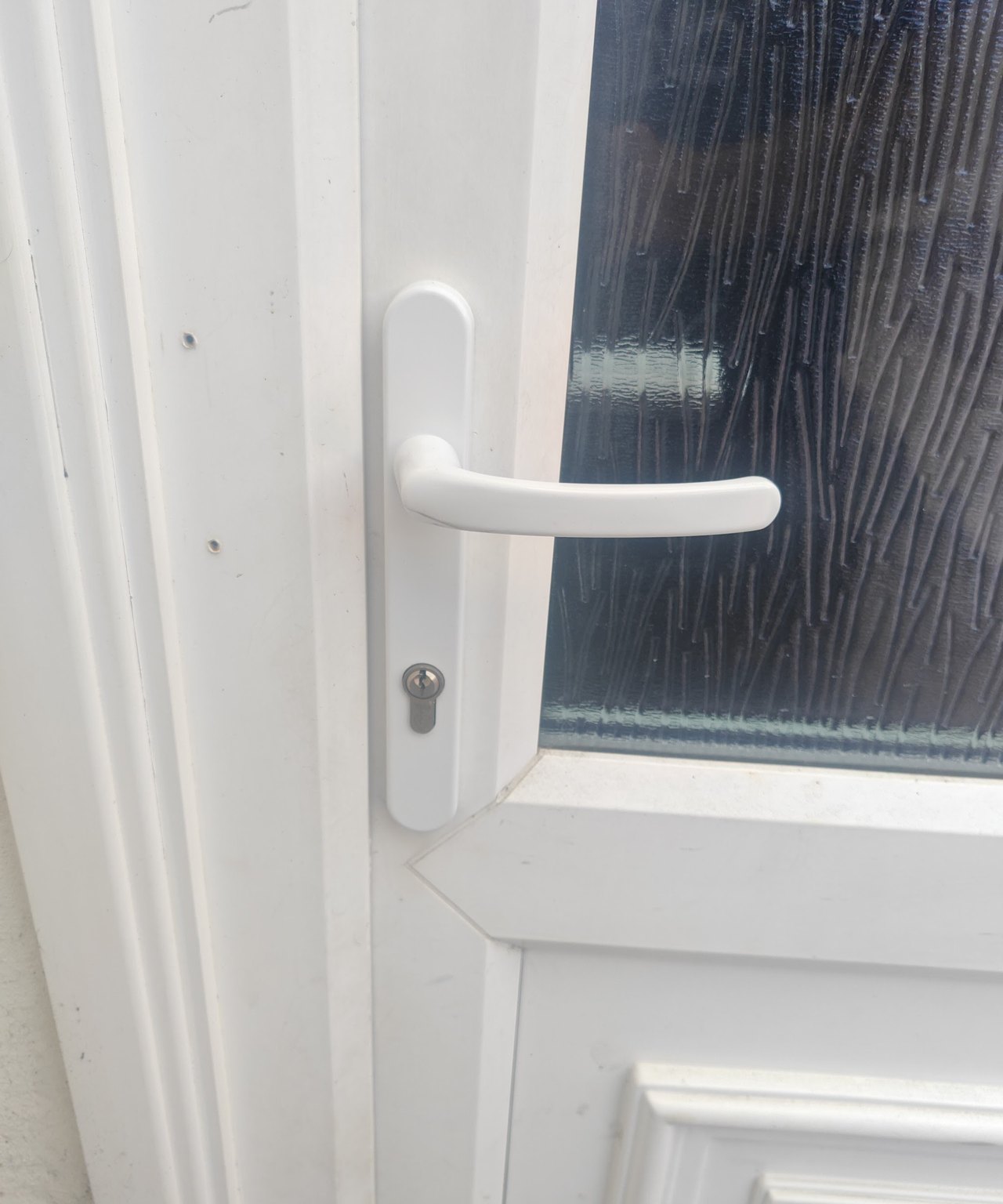 White uPVC back door with a new handle and euro cylinder